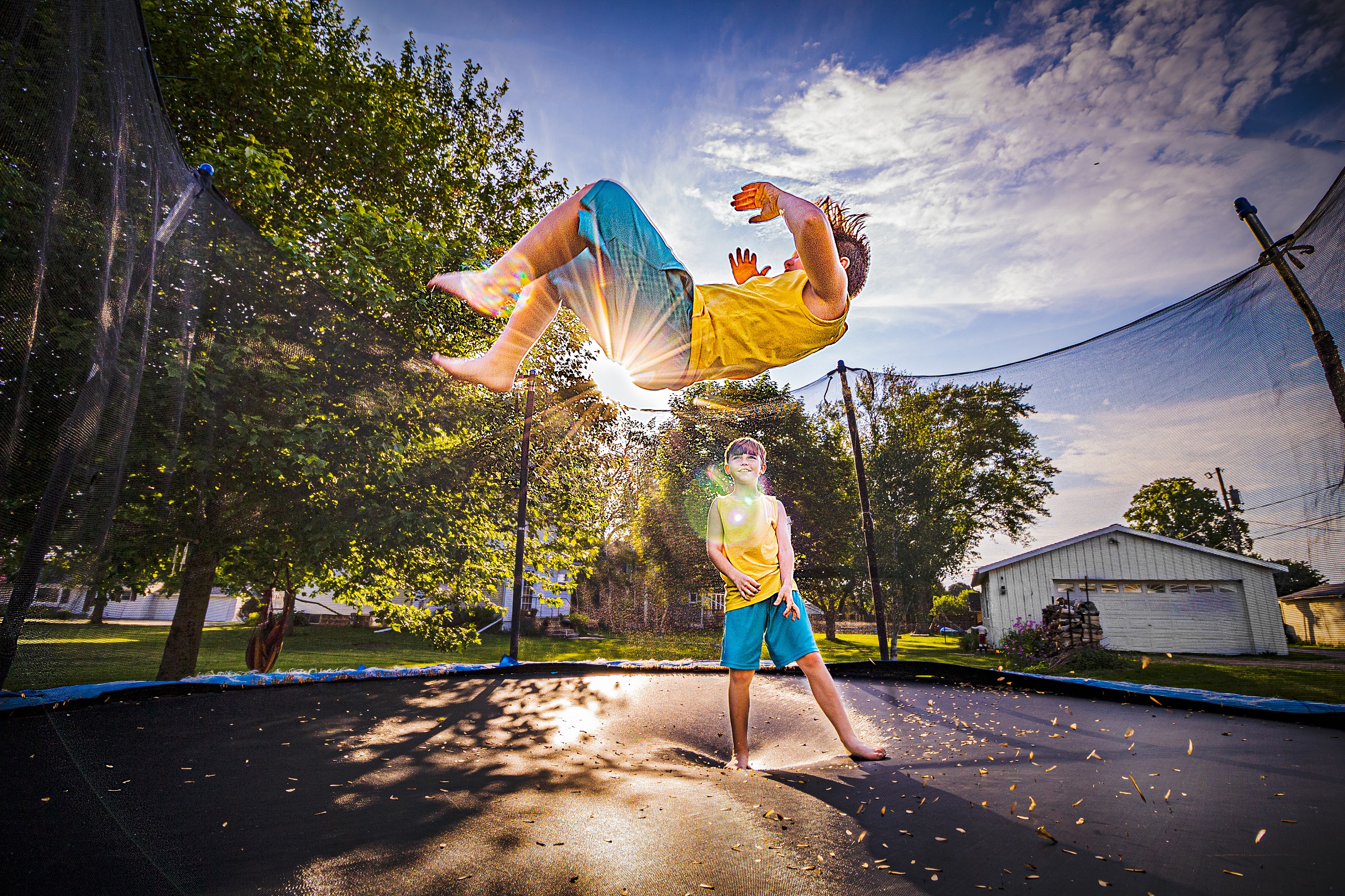 brothers-jumping-on-the-trampoline-in-backyard-2021-09-04-02-18-41-utc.jpg