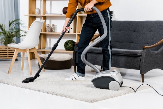 cropped-view-of-man-in-modern-living-room-cleaning-2021-08-31-02-07-26-utc.jpg