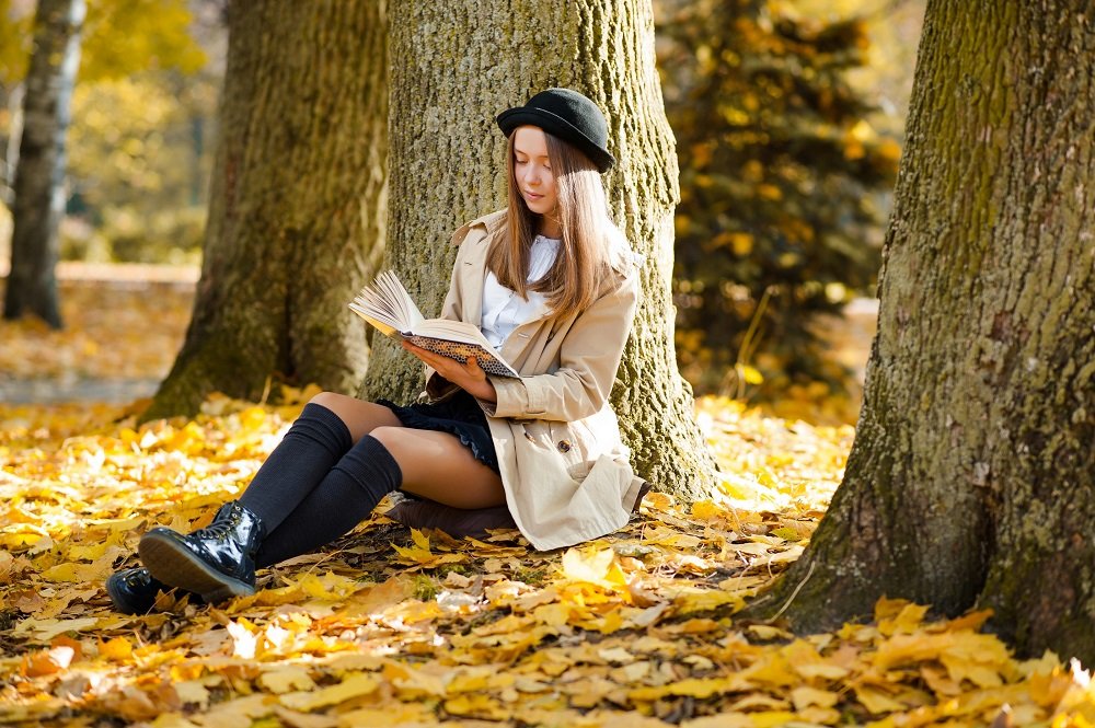 beautiful-young-girl-reading-a-book-near-a-tree-gs8xs3j.jpg