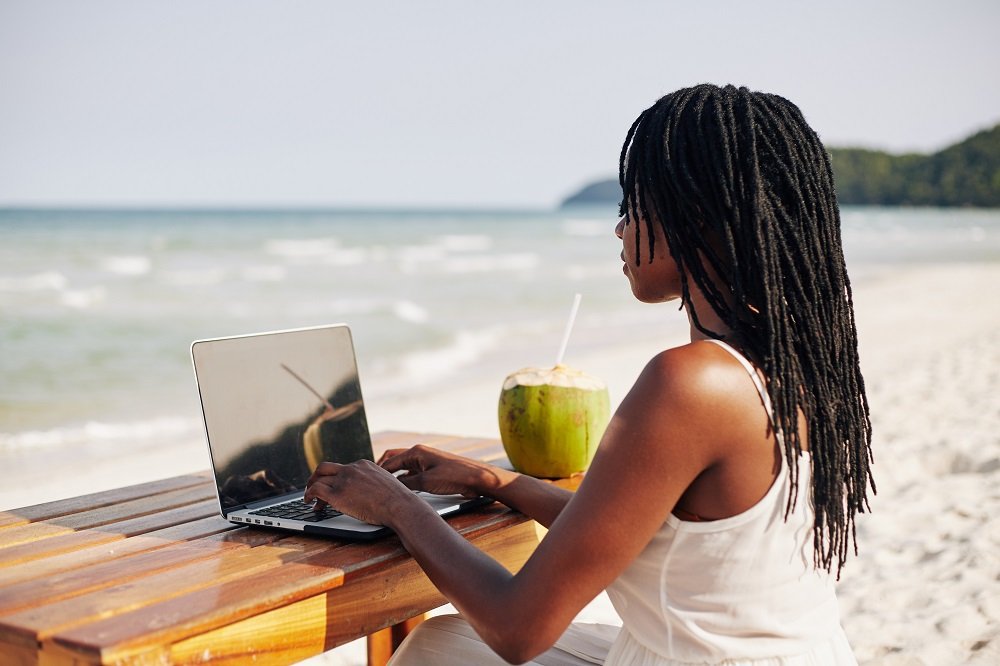 young-woman-working-on-computer-on-beach-2021-08-27-22-32-38-utc.jpg